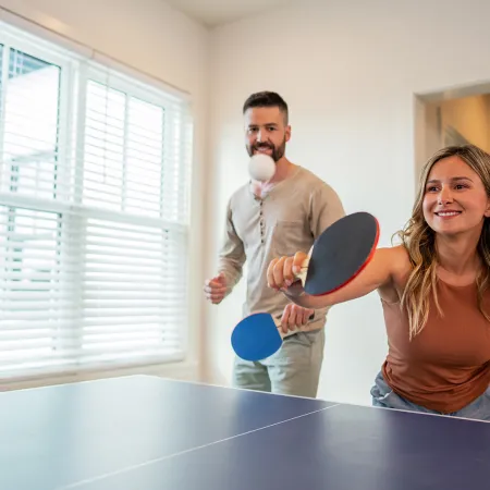 An image of guests playing ping pong in an Evermore House.