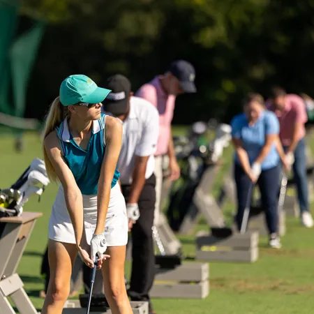 Image of guests participating in a team building activity on the Grand Cypress Golf driving range at Evermore Orlando Resort.