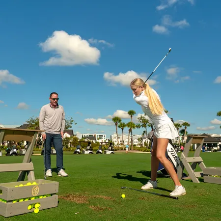 Image of a guest learning from a Grand Cypress Golf professional instructor during a individual golf lesson at Evermore Orlando Resort.