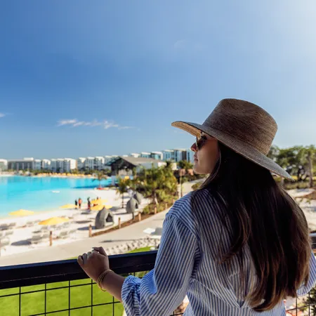Image of a guest relaxing while looking out over Evermore Bay at Evermore Orlando Resort.